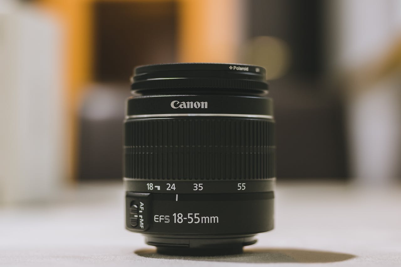 Services Detailed image of a Canon EFS 18-55mm lens with bokeh indoors. Perfect for camera enthusiasts.